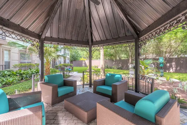 a patio with patio couch and chairs