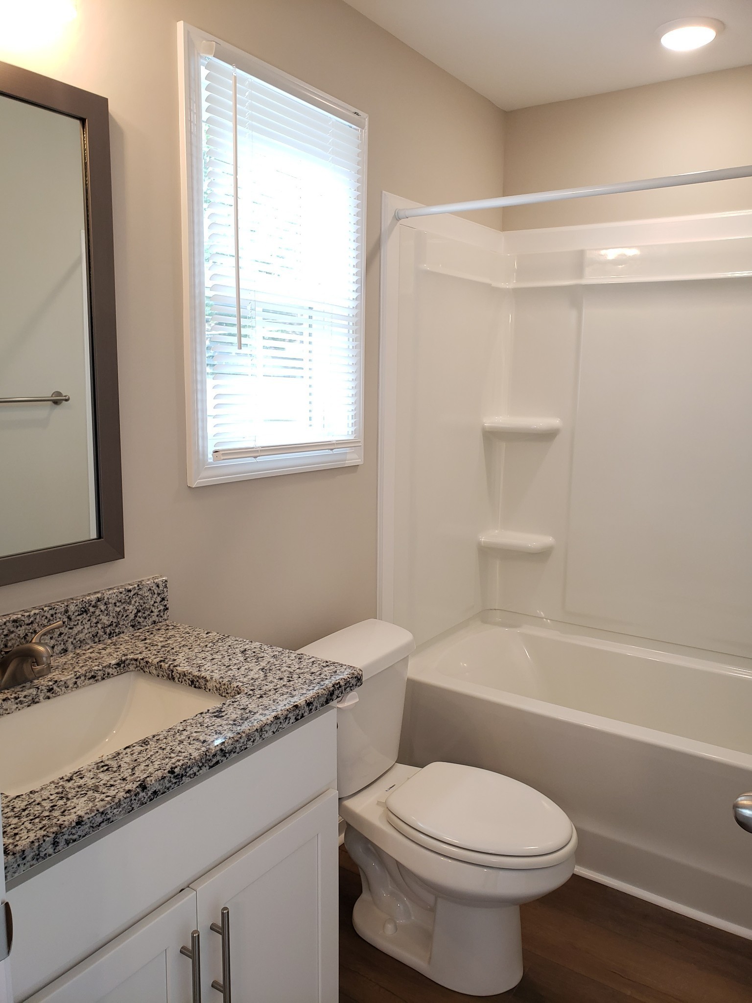 610 Commerce Street, Unit 24 Clarksville, TN 37040 - Photo 14 of 18 a bathroom with a granite countertop toilet sink and shower