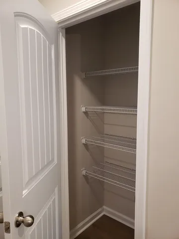 a view of walk in closet with empty racks