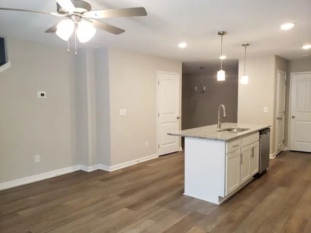 a kitchen with a sink and chandelier