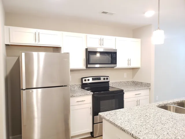 a kitchen with a refrigerator and a sink