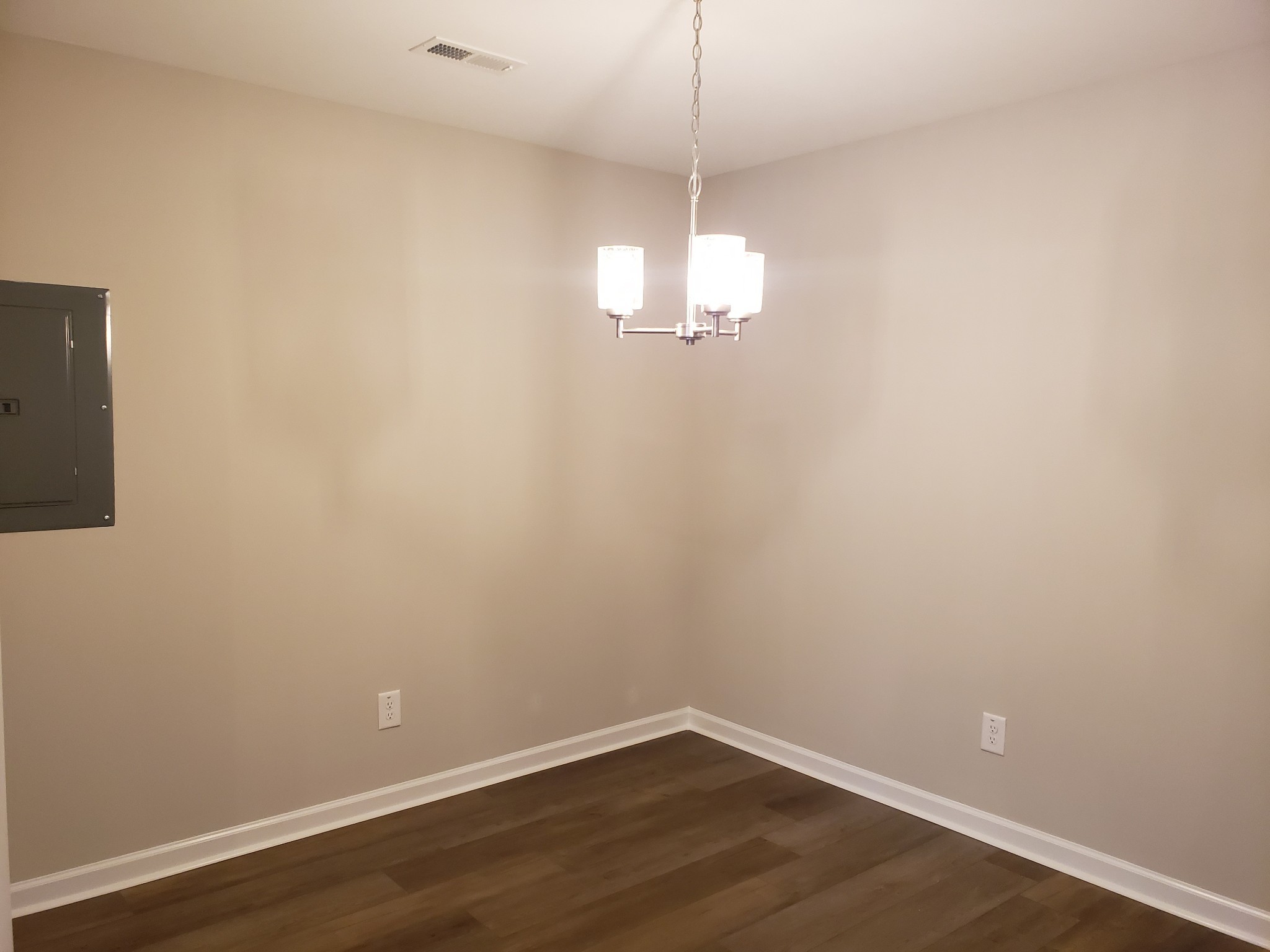 610 Commerce Street, Unit 24 Clarksville, TN 37040 - Photo 9 of 18 a view of a chandelier fan and hardwood floor