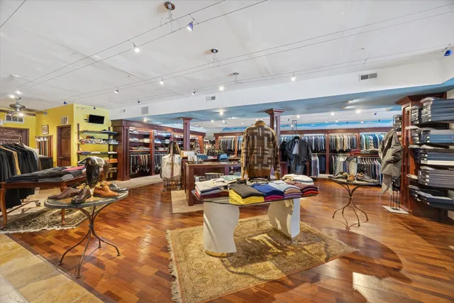 a living room with lots of furniture and clutter