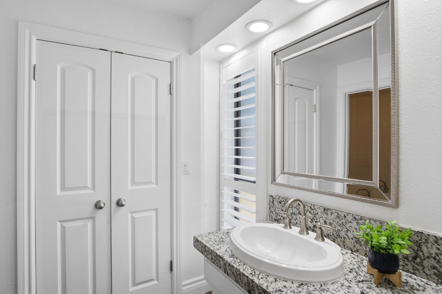 10401 Golf Link Road Turlock, CA 95380 - Photo 20 of 63 a bathroom with a granite countertop sink and a mirror