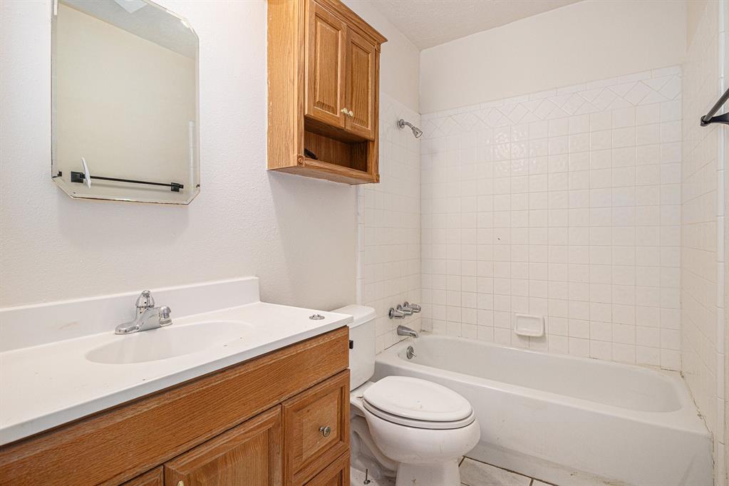 1814 Addington Drive Carrollton, TX 75007 - Photo 16 of 24 Full bathroom with tiled shower / bath, toilet, tile floors, and large vanity
