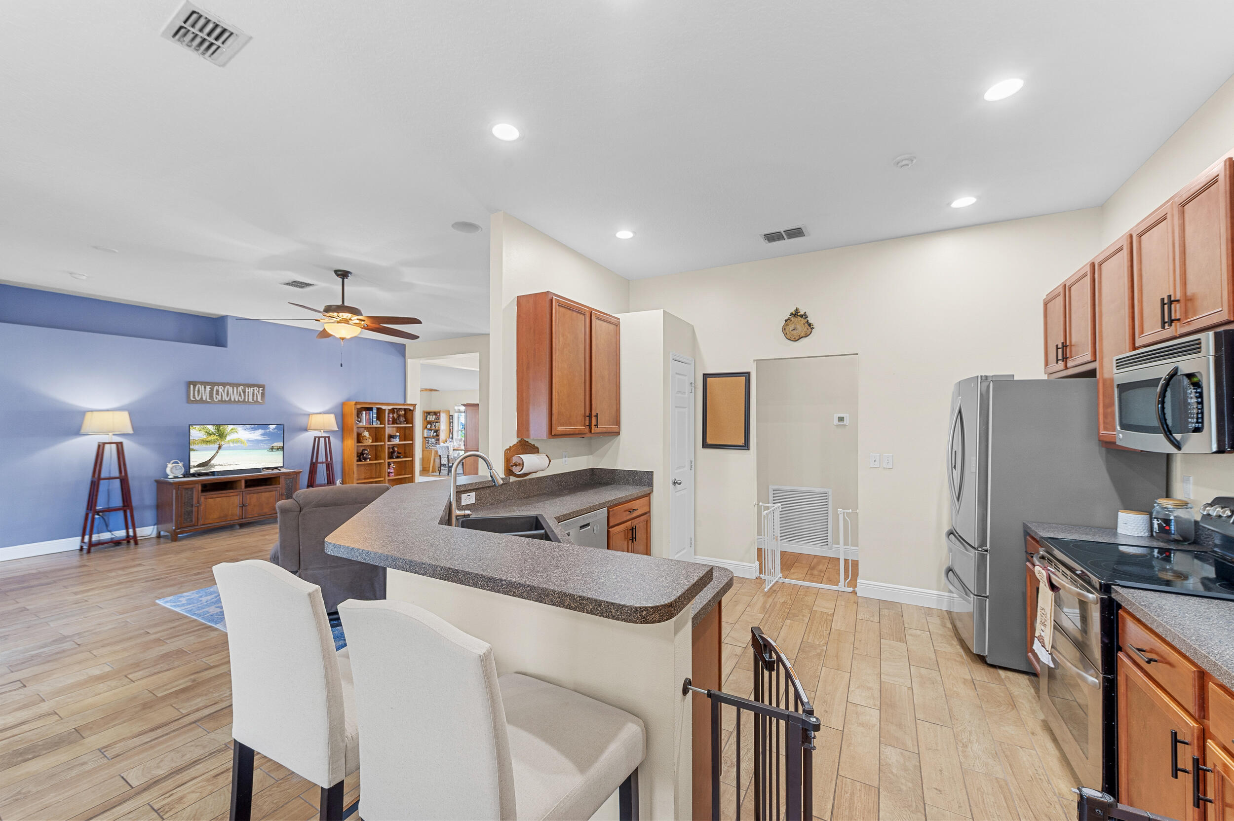 4164 Southwest Spickler Street Port St. Lucie, FL 34953 - Photo 11 of 35 a kitchen with stainless steel appliances granite countertop a sink stove and refrigerator