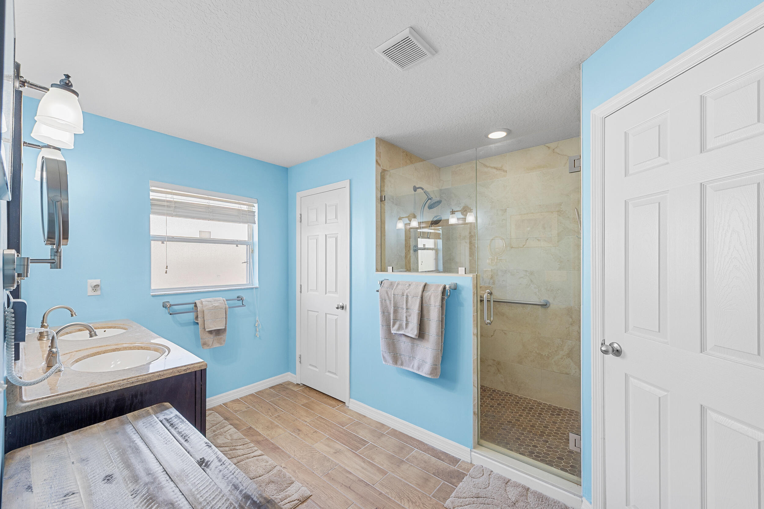 4164 Southwest Spickler Street Port St. Lucie, FL 34953 - Photo 19 of 35 a bedroom with a bed and a bathroom