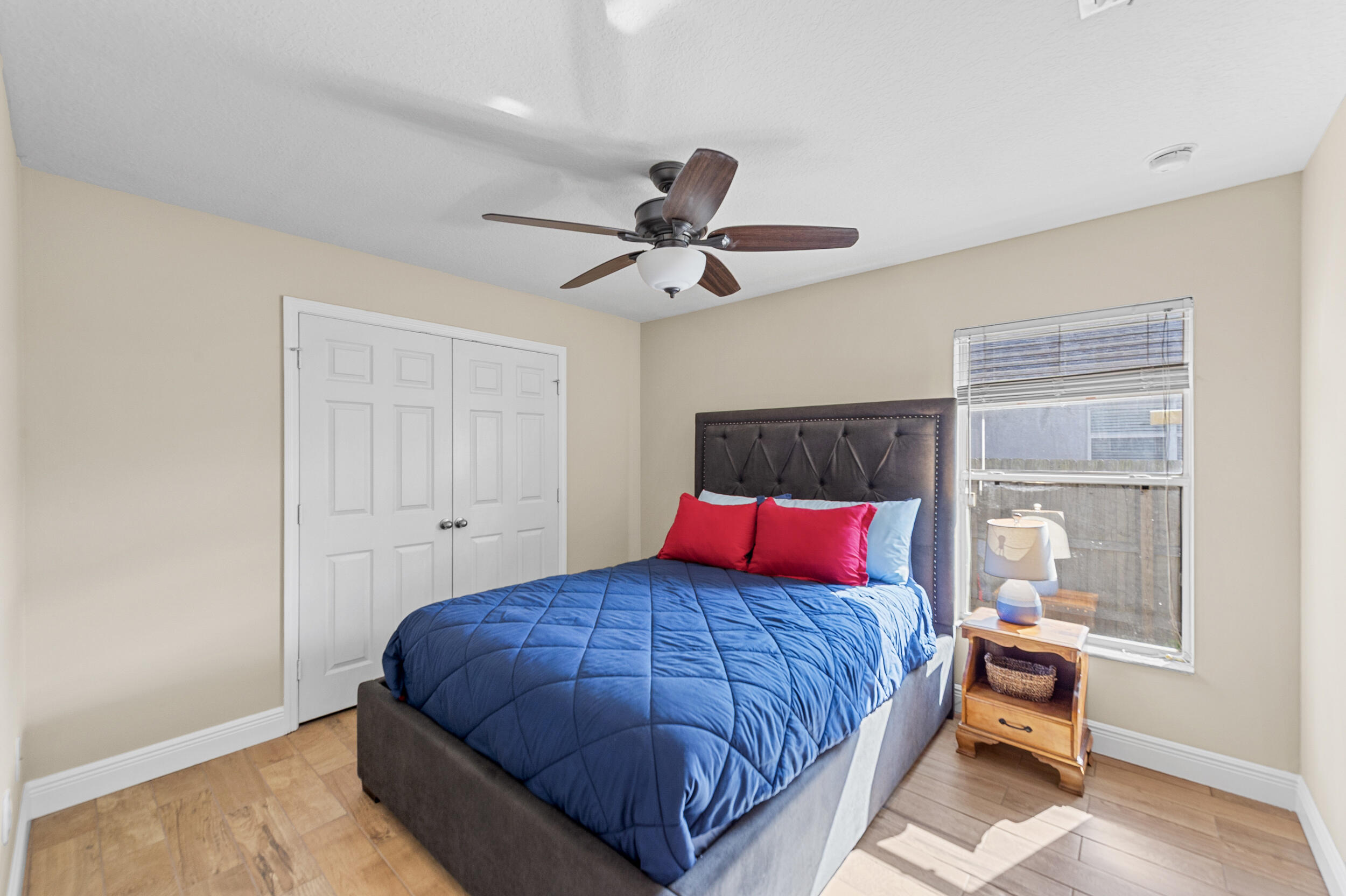 4164 Southwest Spickler Street Port St. Lucie, FL 34953 - Photo 21 of 35 a bedroom with a bed and a window