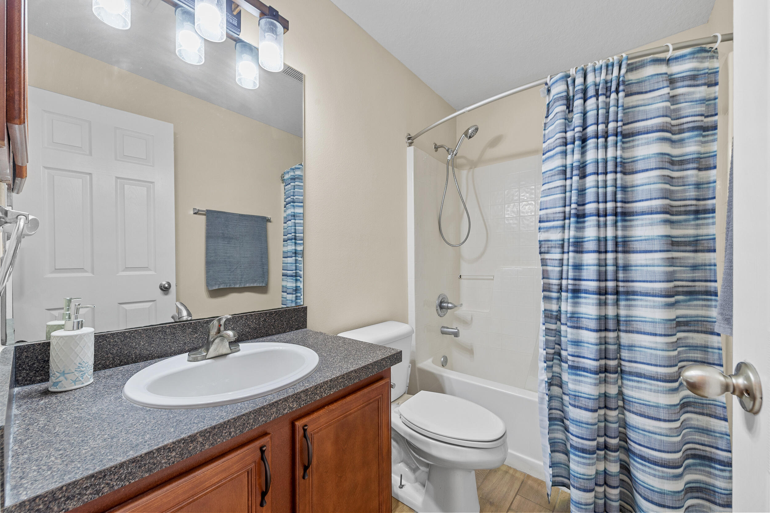 4164 Southwest Spickler Street Port St. Lucie, FL 34953 - Photo 22 of 35 a bathroom with a sink toilet and shower