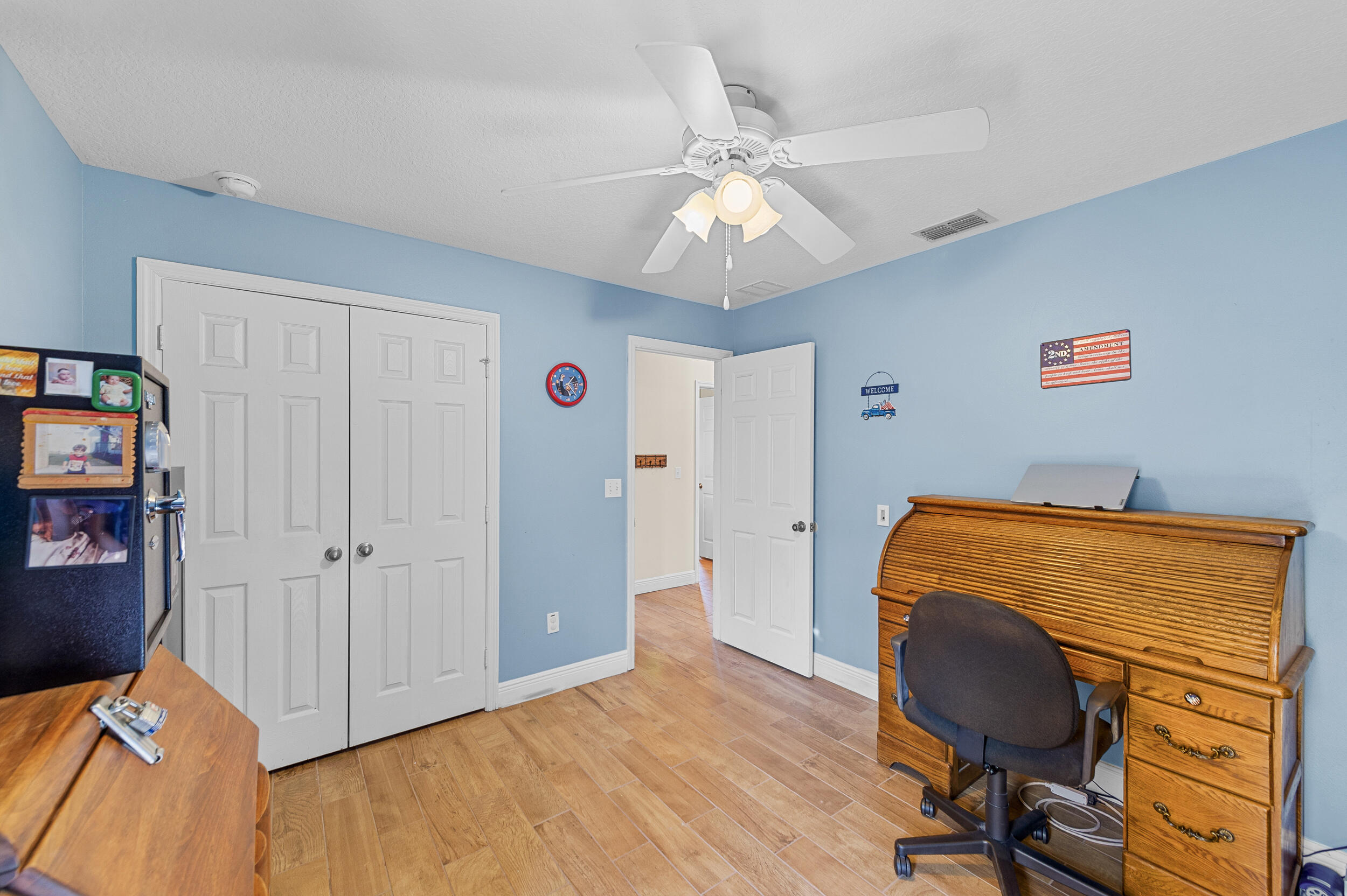 4164 Southwest Spickler Street Port St. Lucie, FL 34953 - Photo 24 of 35 a workspace room with wooden floor closet and windows
