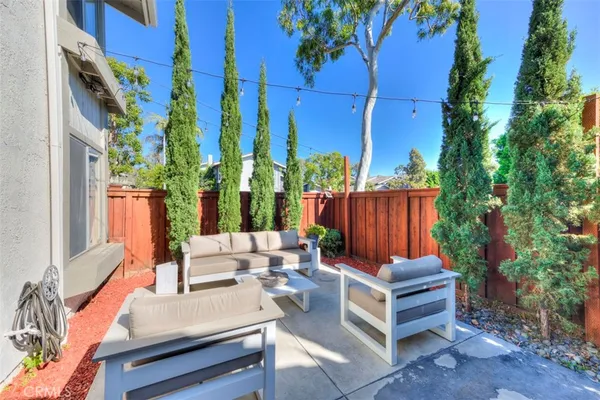 a view of a house with backyard and sitting area