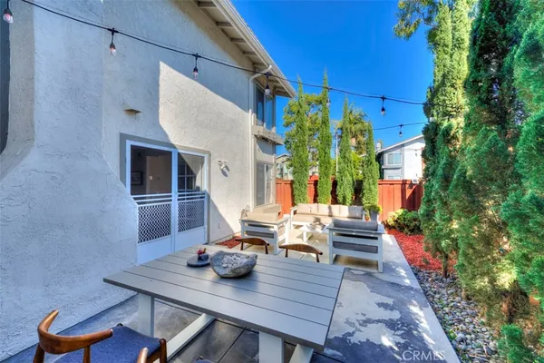 a backyard of a house with table and chairs