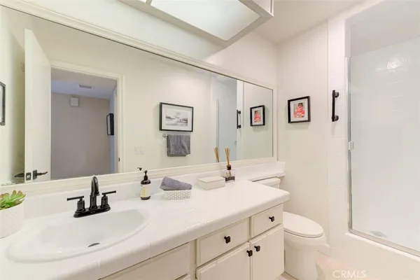 a bedroom with furniture and a large window