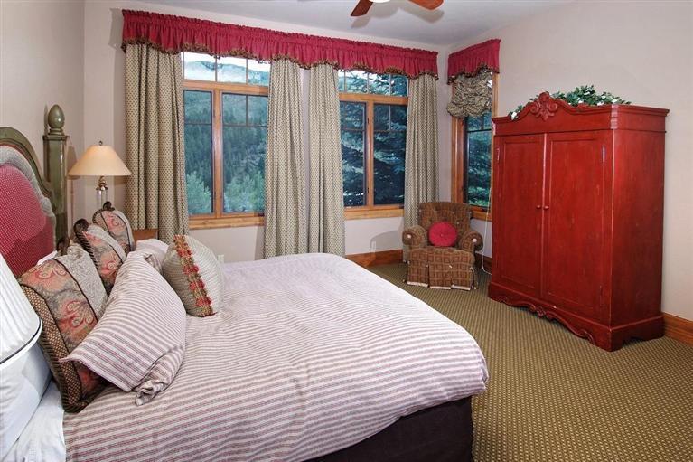 59 Borders Road Beaver Creek, CO 81620 - Photo 15 of 25 a bedroom with a bed and large windows