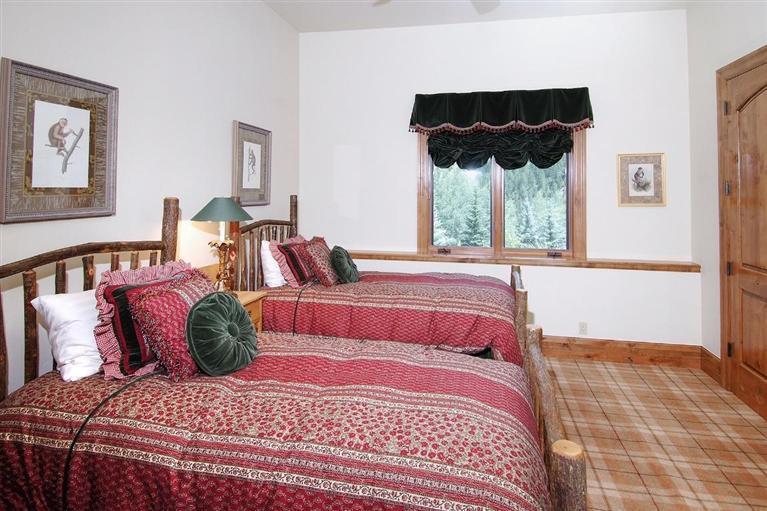 59 Borders Road Beaver Creek, CO 81620 - Photo 17 of 25 a bedroom with a bed a lamp and a large window