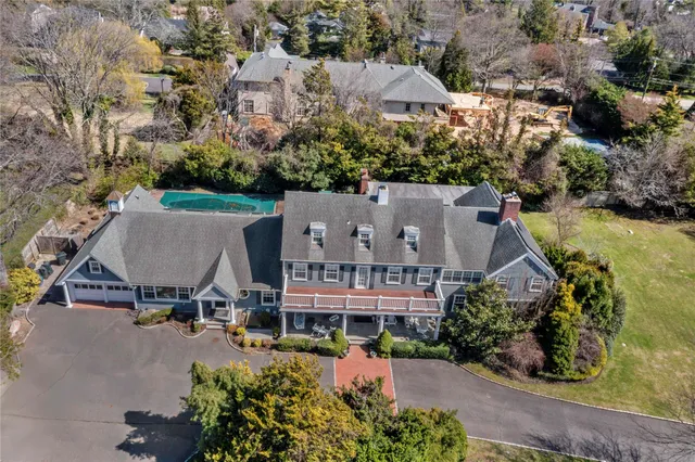 an aerial view of multiple houses with a yard