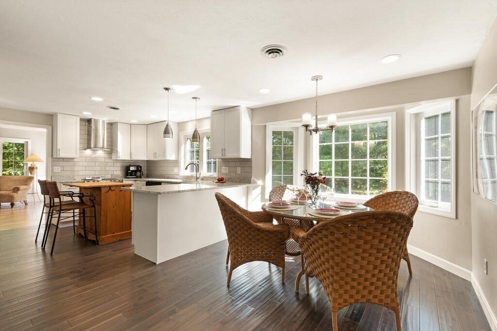 17 Azalea Road Sharon, MA 02067 - Photo 12 of 35 a dining room with kitchen island granite countertop wooden floor and a refrigerator