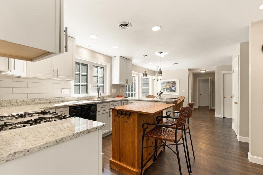 17 Azalea Road Sharon, MA 02067 - Photo 14 of 35 a kitchen with a stove a table and chairs in it