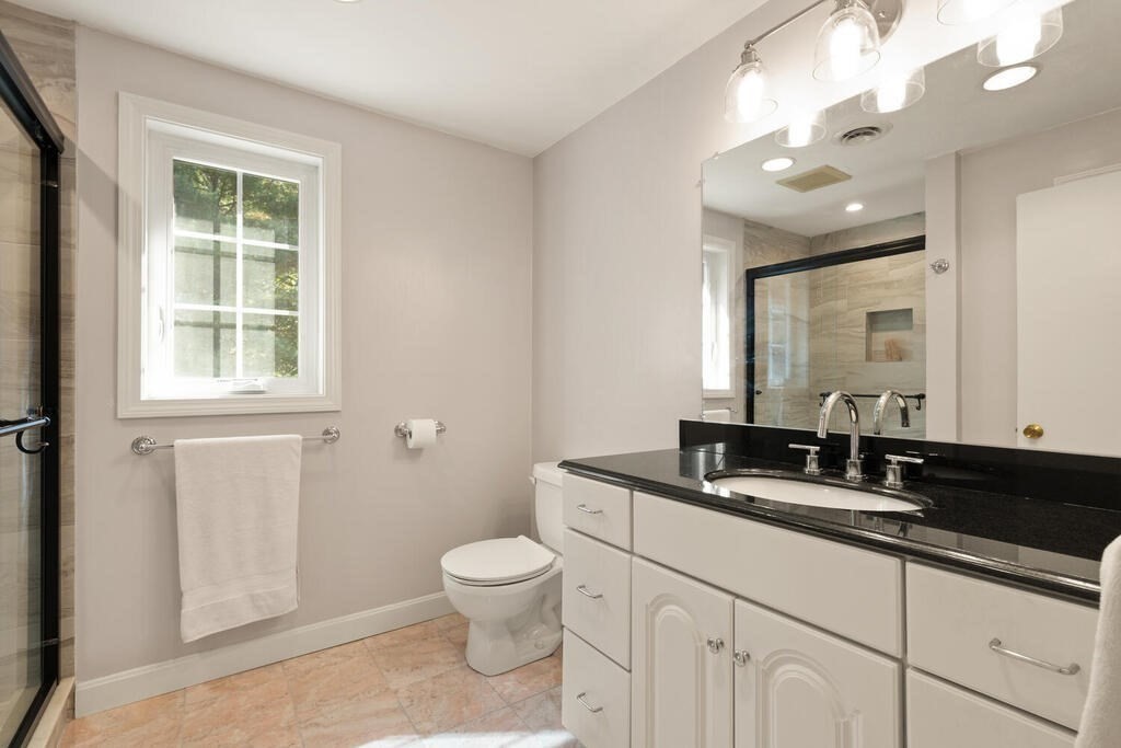 17 Azalea Road Sharon, MA 02067 - Photo 22 of 35 a bathroom with a toilet a sink and mirror