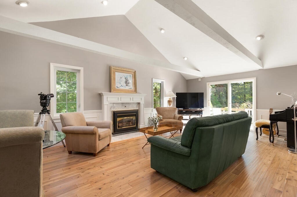 17 Azalea Road Sharon, MA 02067 - Photo 8 of 35 a living room with furniture flat screen tv and a fireplace