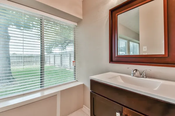 a bathroom with a sink and a window