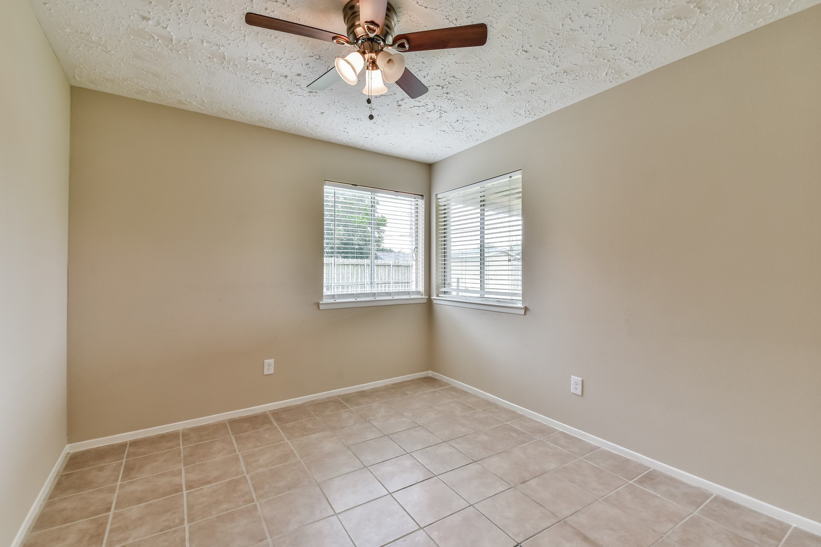 9503 Bent Spur Lane Houston, TX 77064 - Photo 19 of 28 an empty room with windows and fan