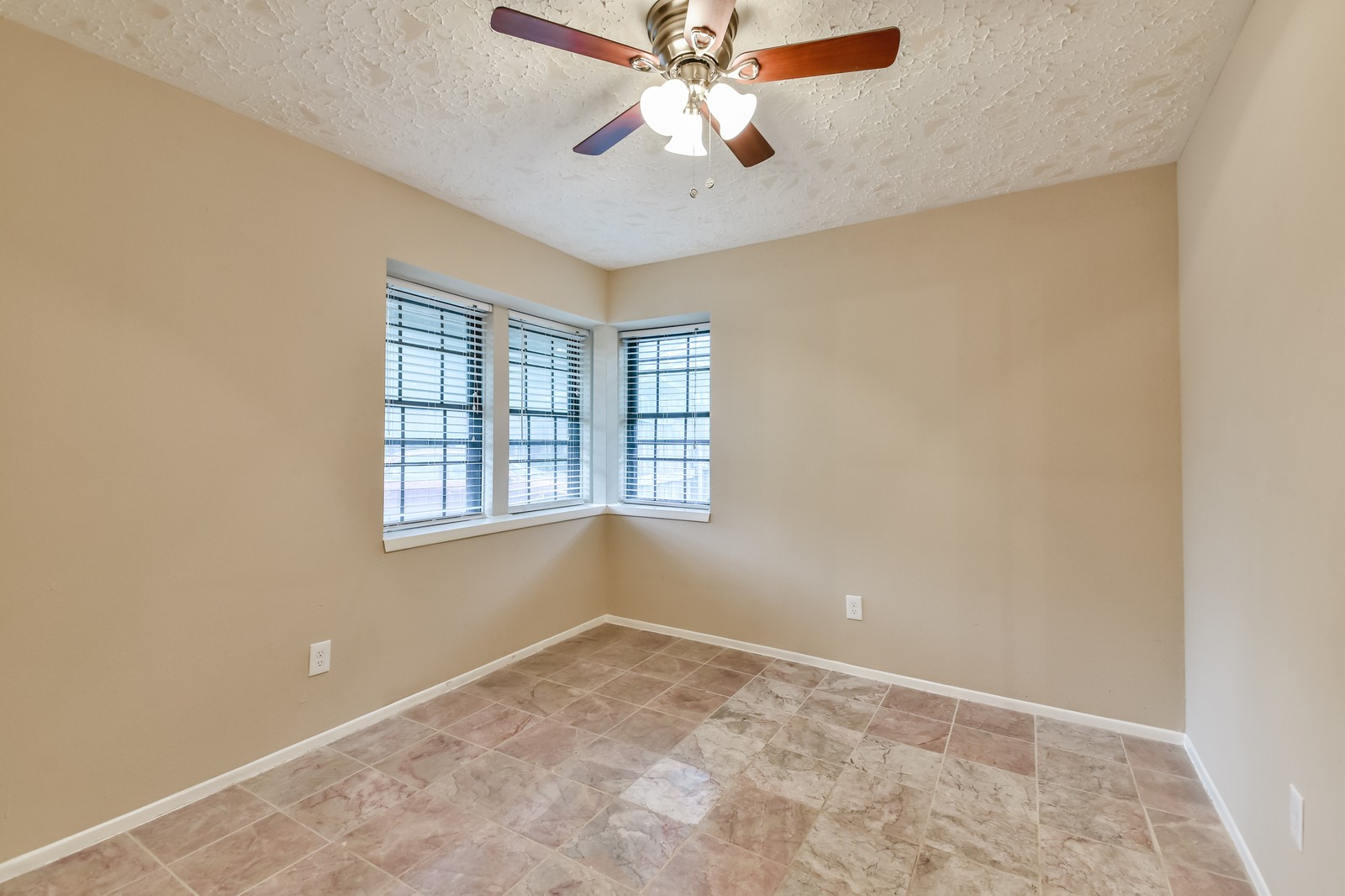 9503 Bent Spur Lane Houston, TX 77064 - Photo 24 of 28 an empty room with windows and fan