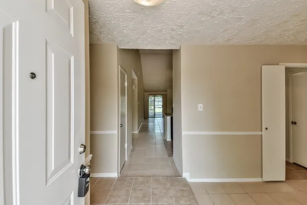 a view of a hallway with wooden shelves