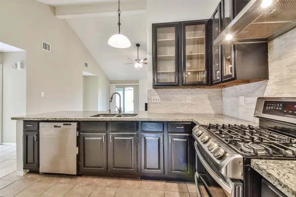 a kitchen with a stove and a sink