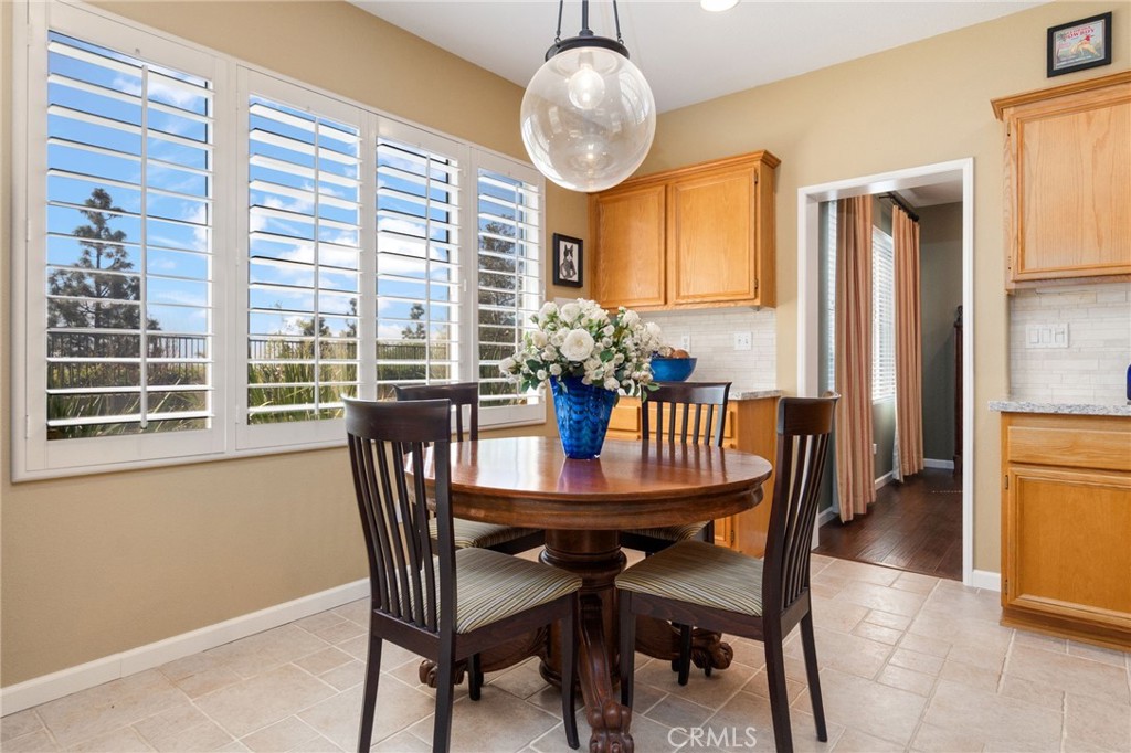 13939 Guidera Drive Rancho Cucamonga, CA 91739 - Photo 12 of 46 a dining room with furniture window and wooden floor