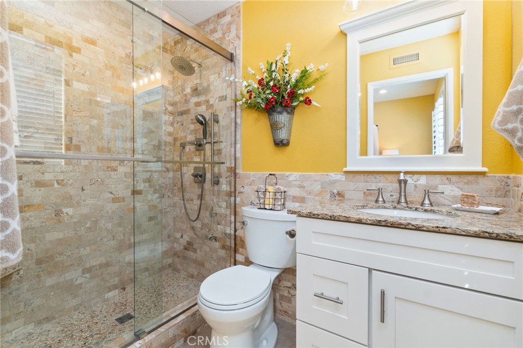 13939 Guidera Drive Rancho Cucamonga, CA 91739 - Photo 17 of 46 a bathroom with a granite countertop sink toilet and shower