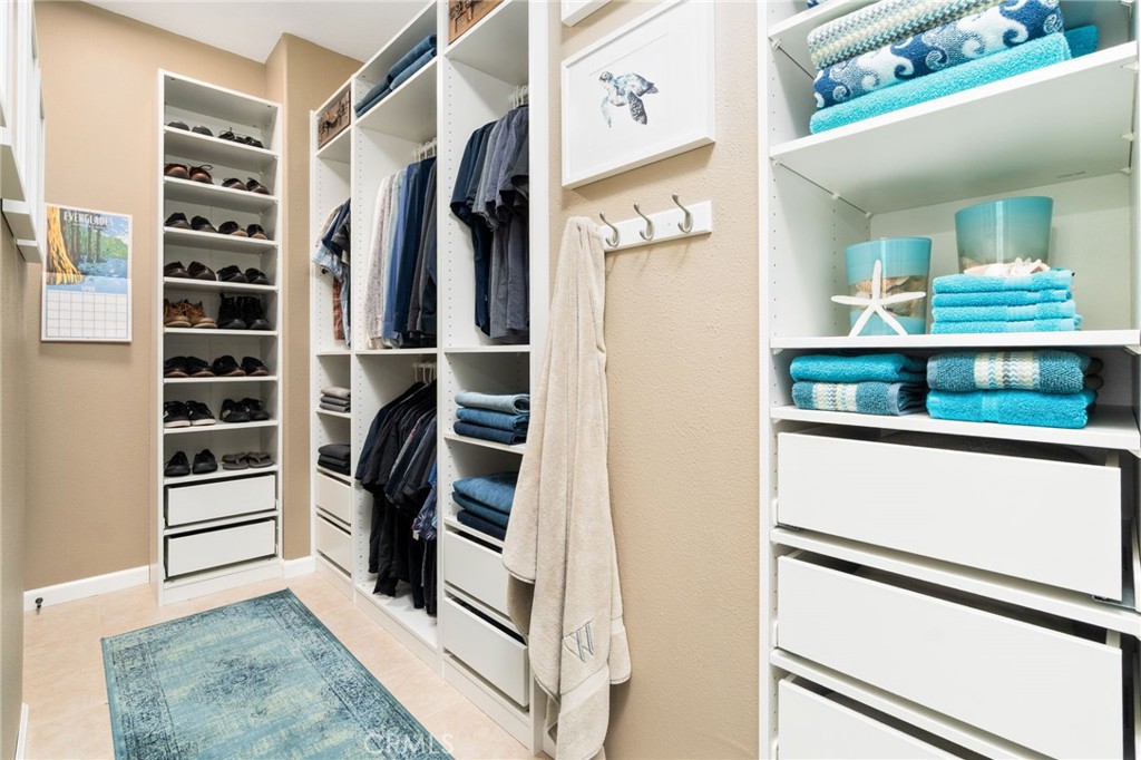 13939 Guidera Drive Rancho Cucamonga, CA 91739 - Photo 29 of 46 a view of walk in closet with clothes and shoes