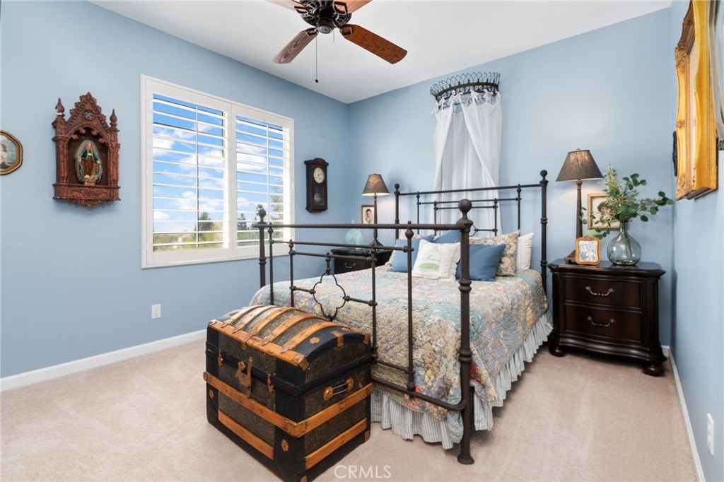 13939 Guidera Drive Rancho Cucamonga, CA 91739 - Photo 32 of 46 a bed room with a bed and a chandelier