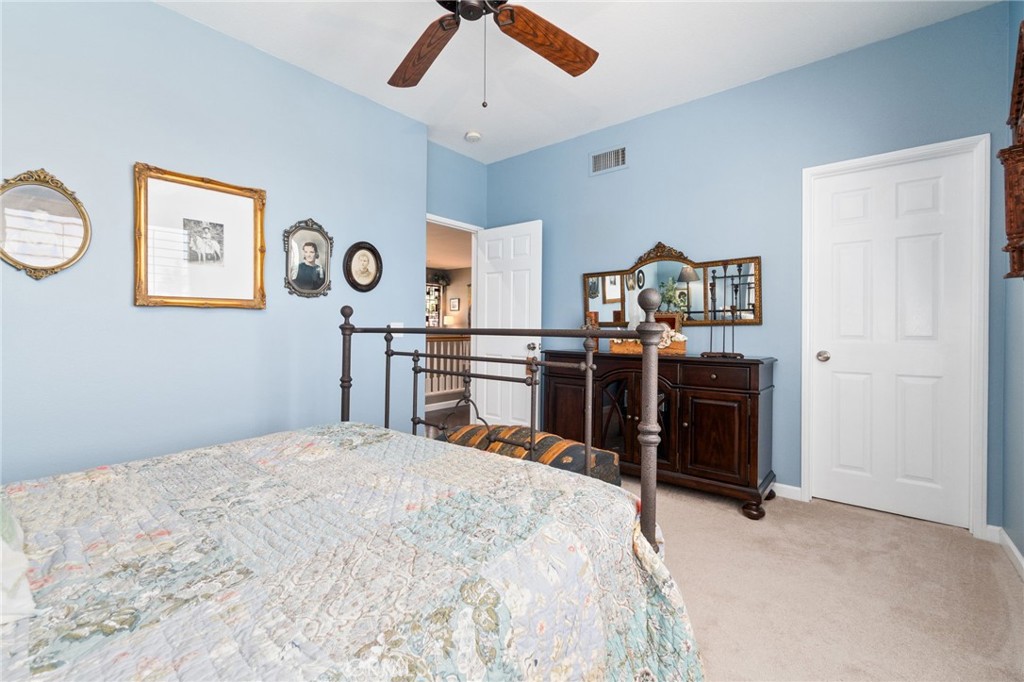 13939 Guidera Drive Rancho Cucamonga, CA 91739 - Photo 33 of 46 a bed room with a bed and a chandelier