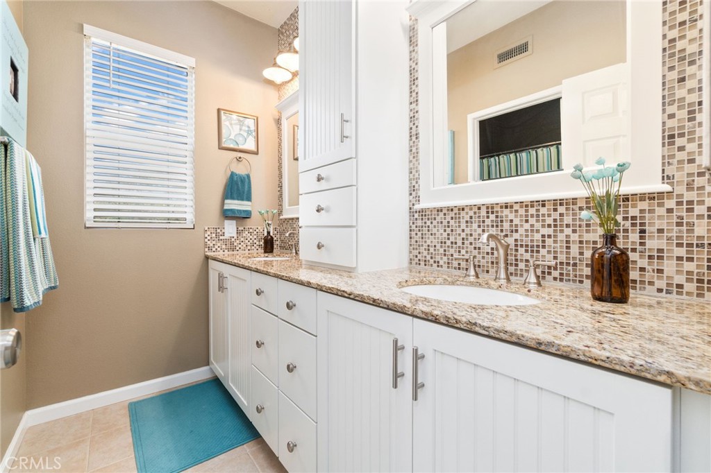 13939 Guidera Drive Rancho Cucamonga, CA 91739 - Photo 34 of 46 a bathroom with a granite countertop sink mirror and a