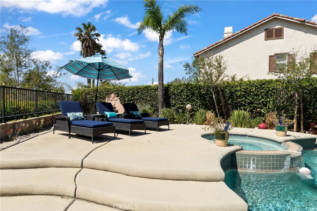 13939 Guidera Drive Rancho Cucamonga, CA 91739 - Photo 43 of 46 a view of a patio with a table and chairs under an umbrella