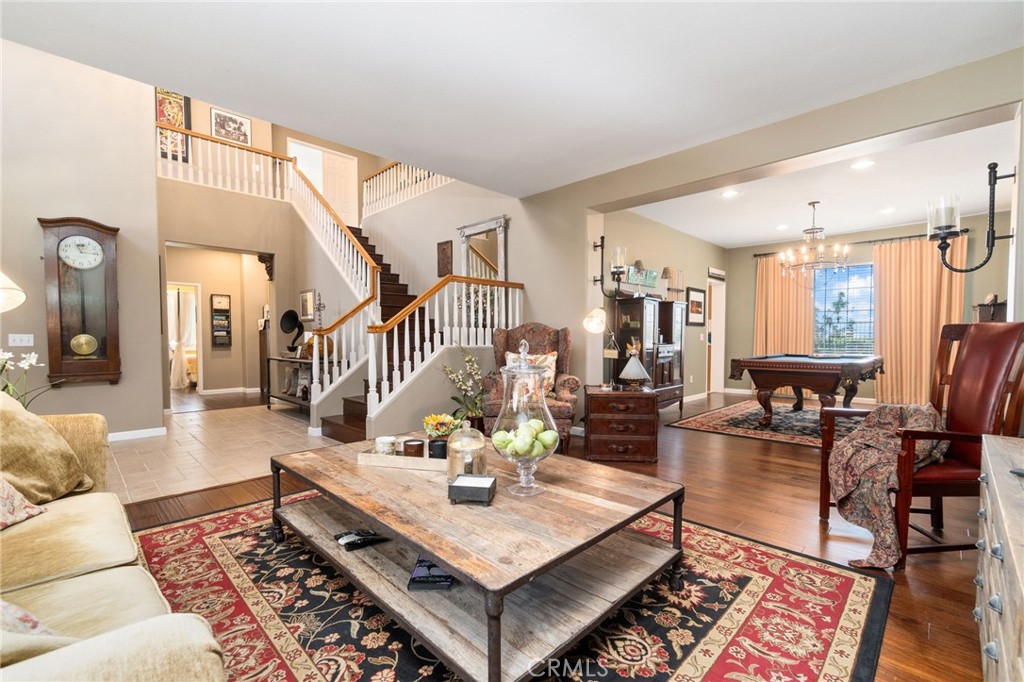 13939 Guidera Drive Rancho Cucamonga, CA 91739 - Photo 6 of 46 a living room with furniture a rug and a chandelier