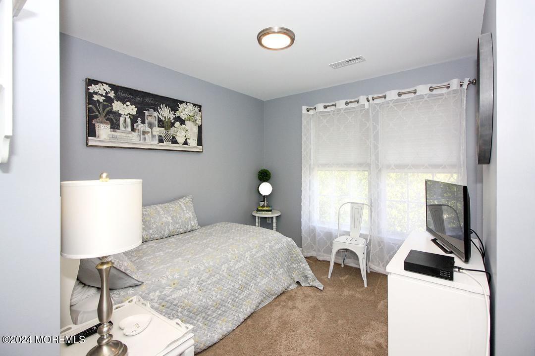 19 Saxton Road, Unit 58 Farmingdale, NJ 07727 - Photo 20 of 31 a bedroom with a bed and a table