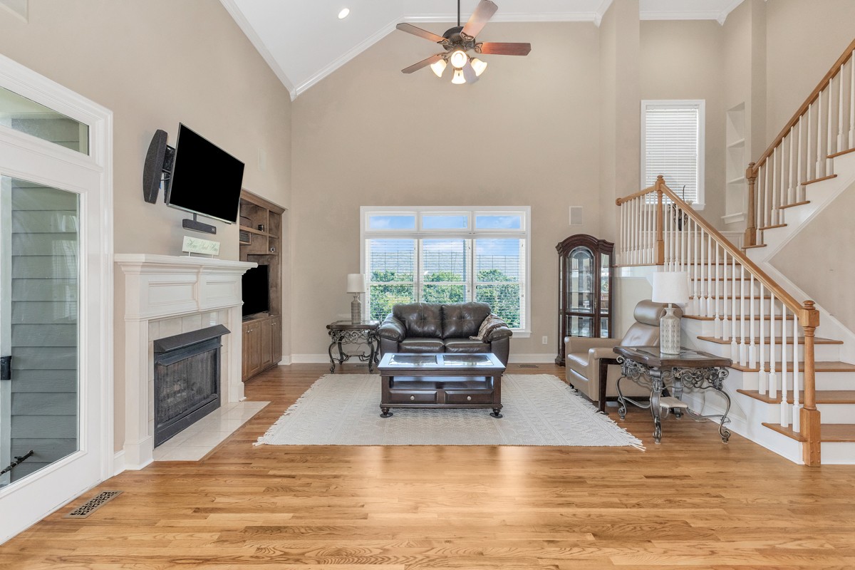 11035 Mathis Mountain Road Southeast Huntsville, AL 35803 - Photo 20 of 40 a living room with furniture a fireplace and a flat screen tv