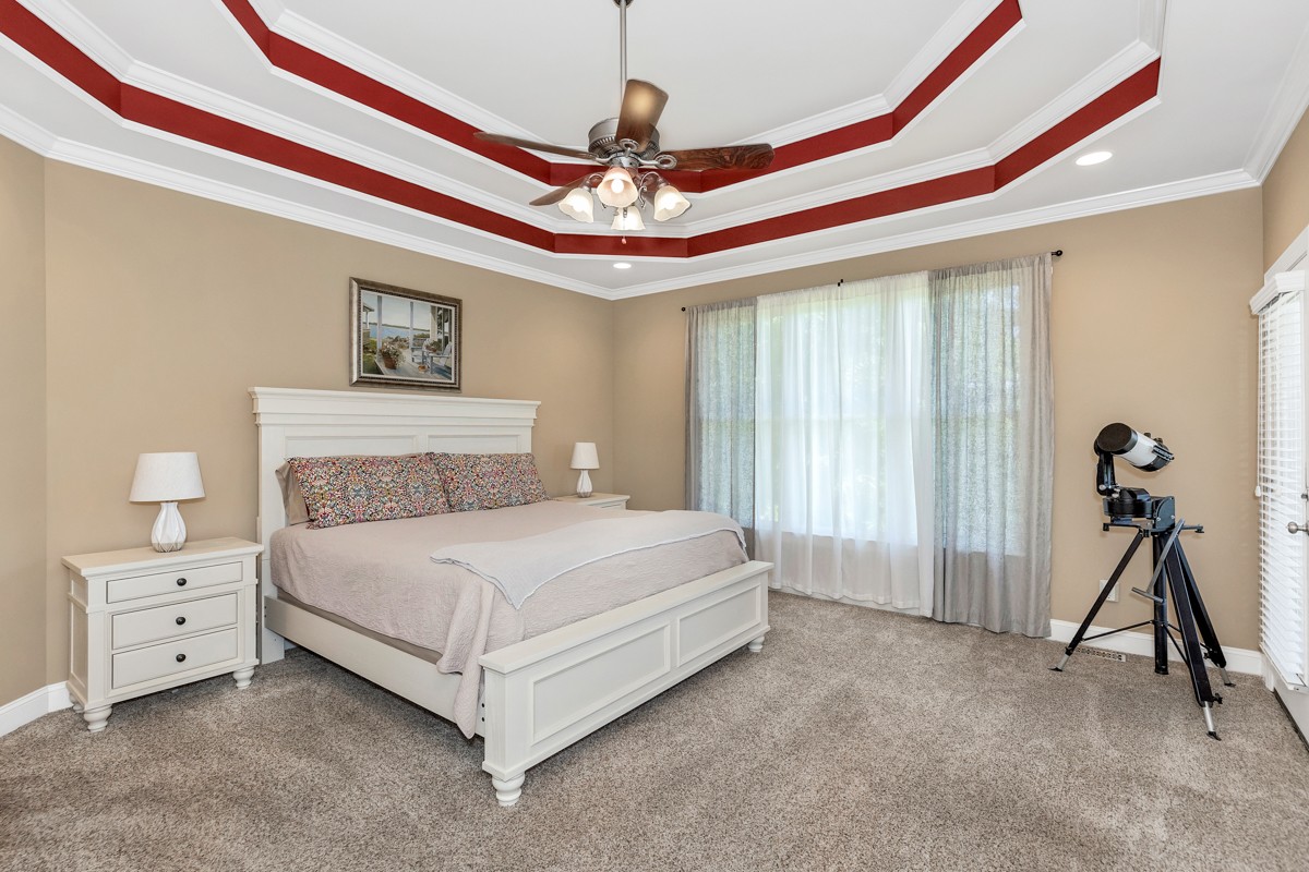 11035 Mathis Mountain Road Southeast Huntsville, AL 35803 - Photo 23 of 40 a bedroom with a bed and a chandelier