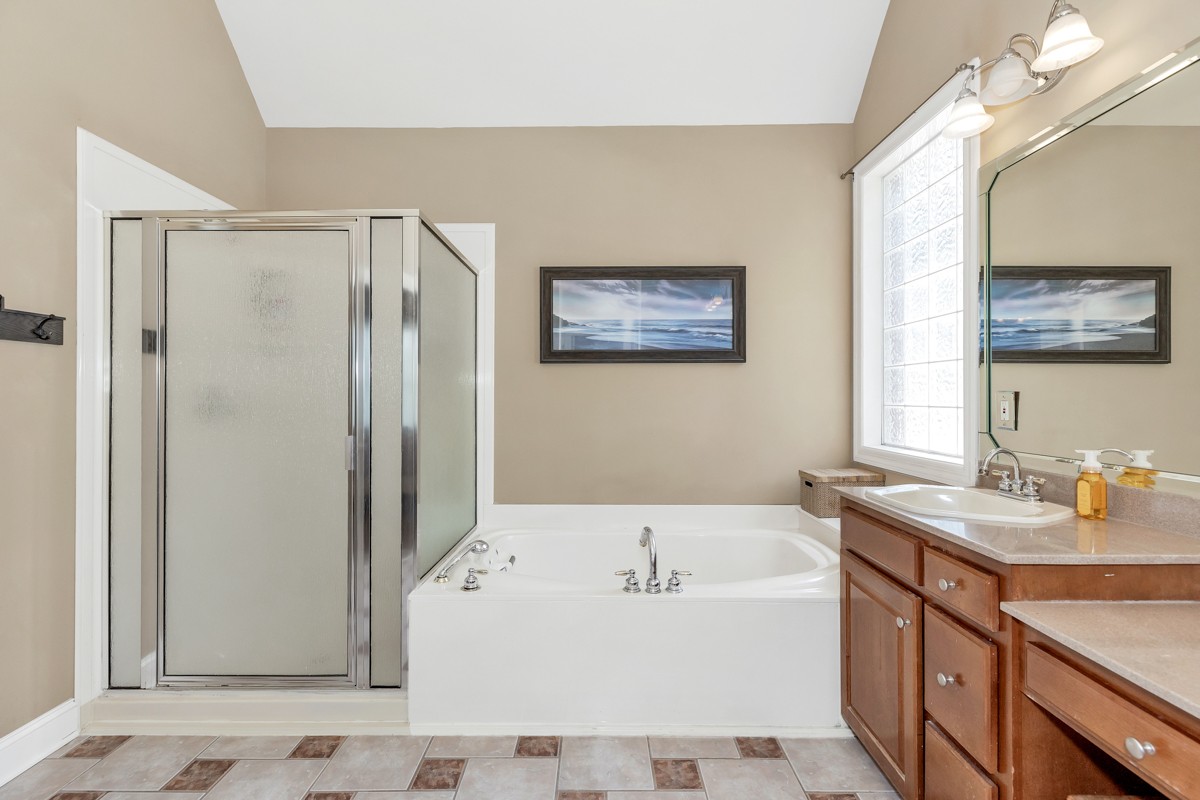 11035 Mathis Mountain Road Southeast Huntsville, AL 35803 - Photo 24 of 40 a bathroom with a tub a sink and a mirror