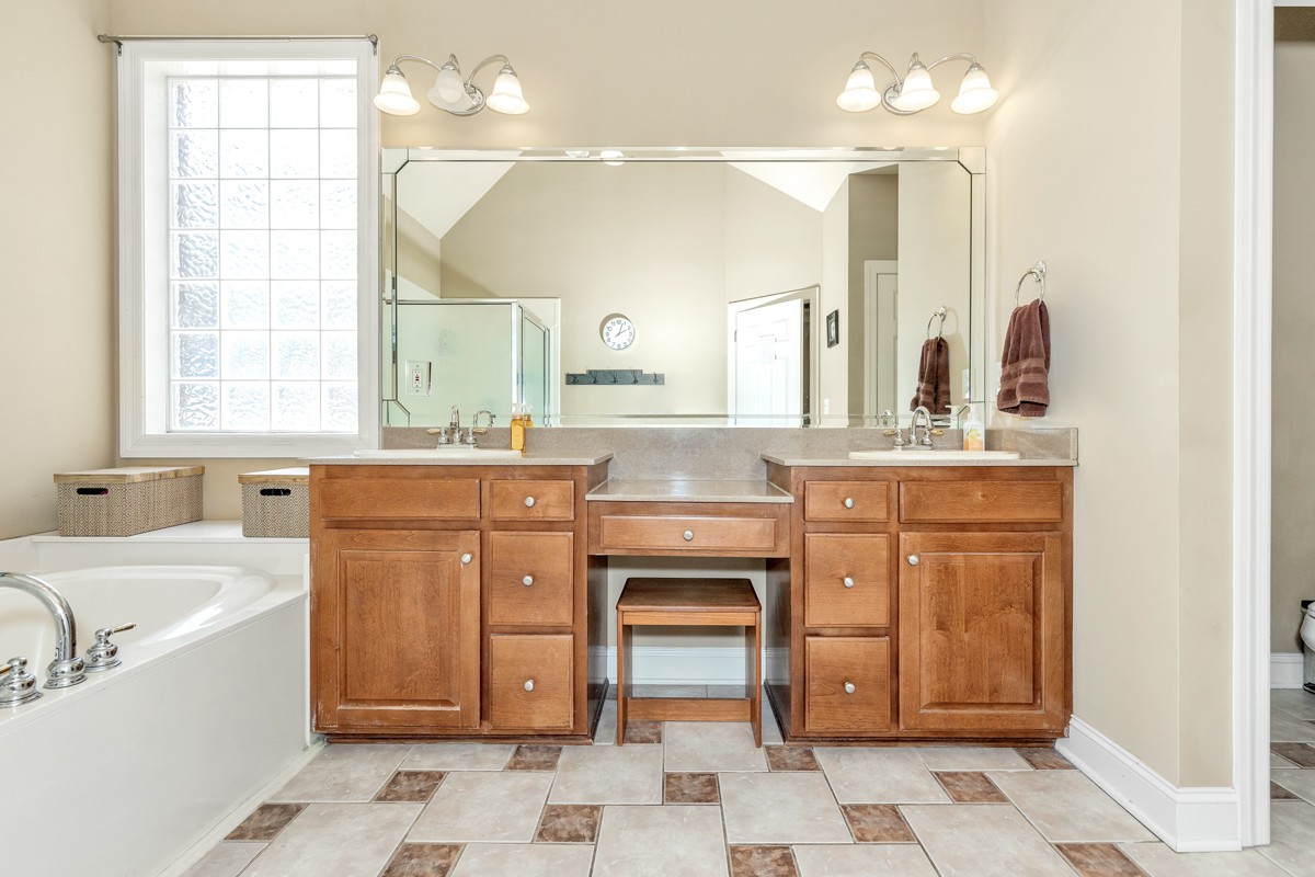 11035 Mathis Mountain Road Southeast Huntsville, AL 35803 - Photo 26 of 40 a bathroom with a sink vanity granite toilet and a mirror