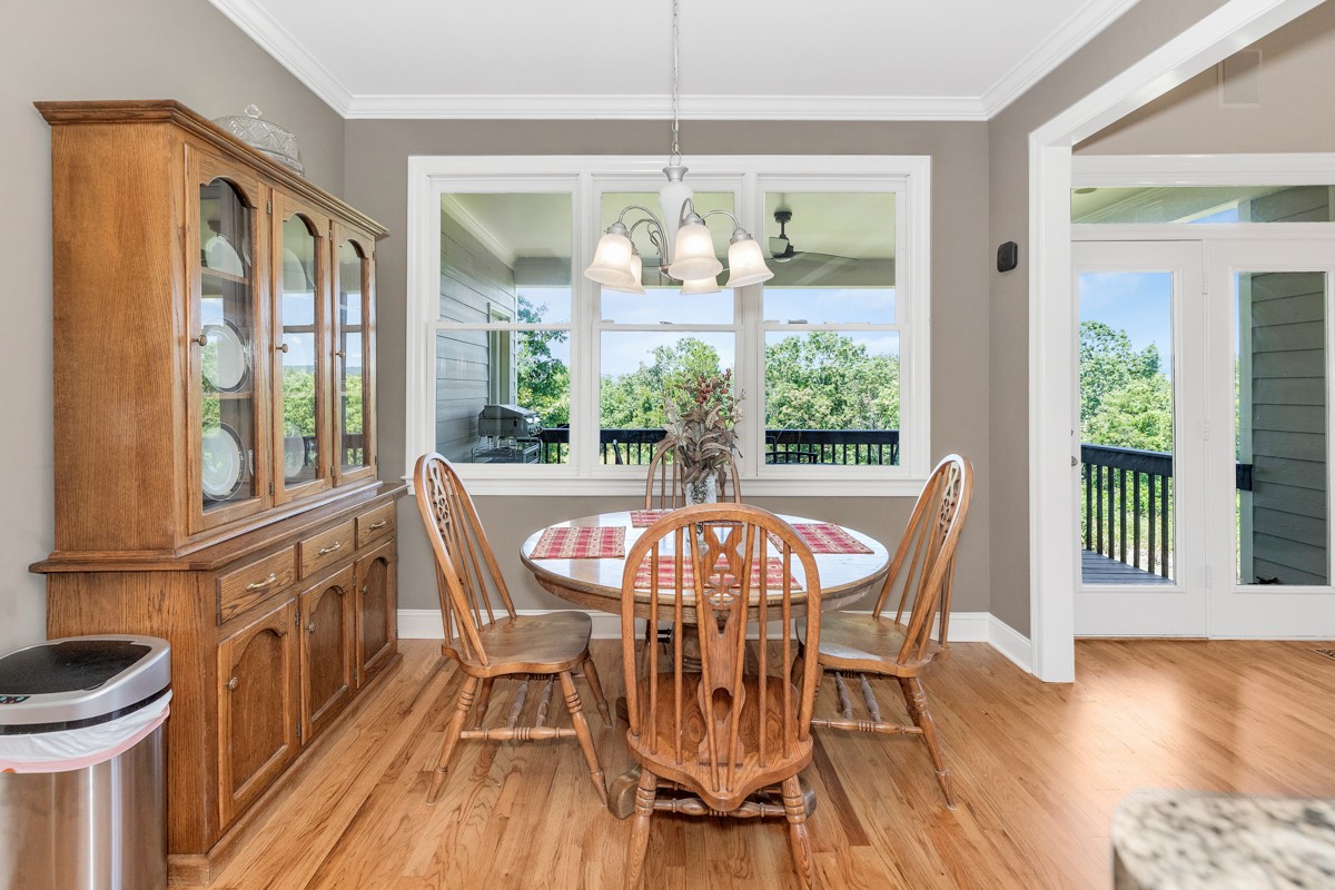 11035 Mathis Mountain Road Southeast Huntsville, AL 35803 - Photo 27 of 40 a view of a dining room with furniture window and wooden floor