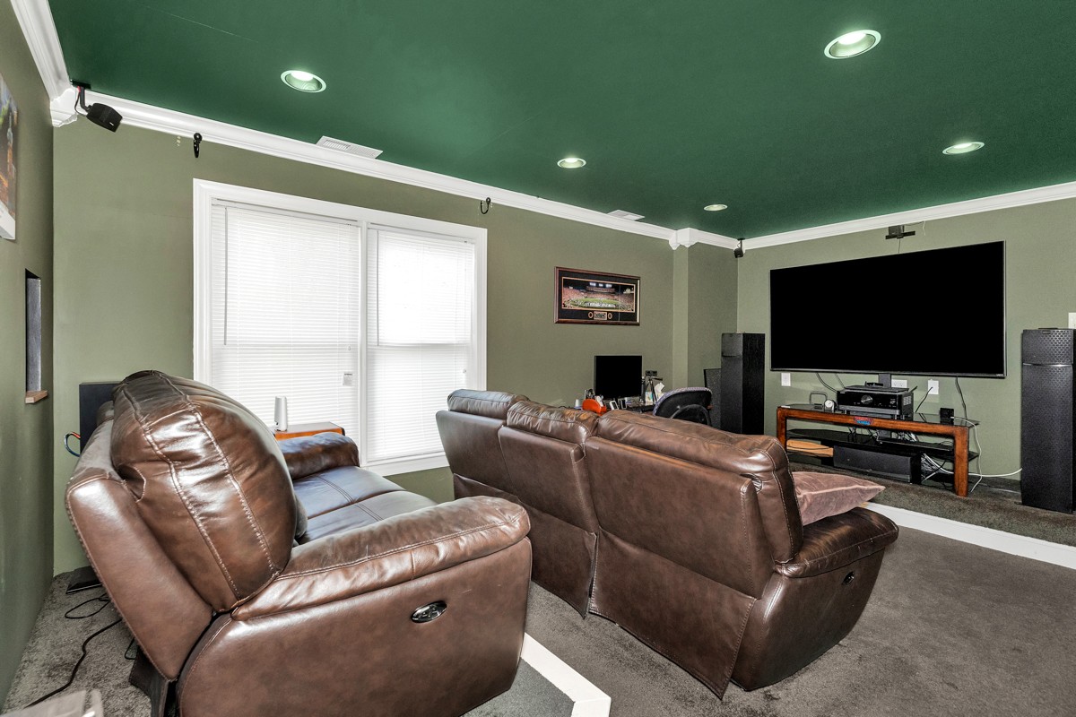 11035 Mathis Mountain Road Southeast Huntsville, AL 35803 - Photo 29 of 40 a living room with furniture and a flat screen tv