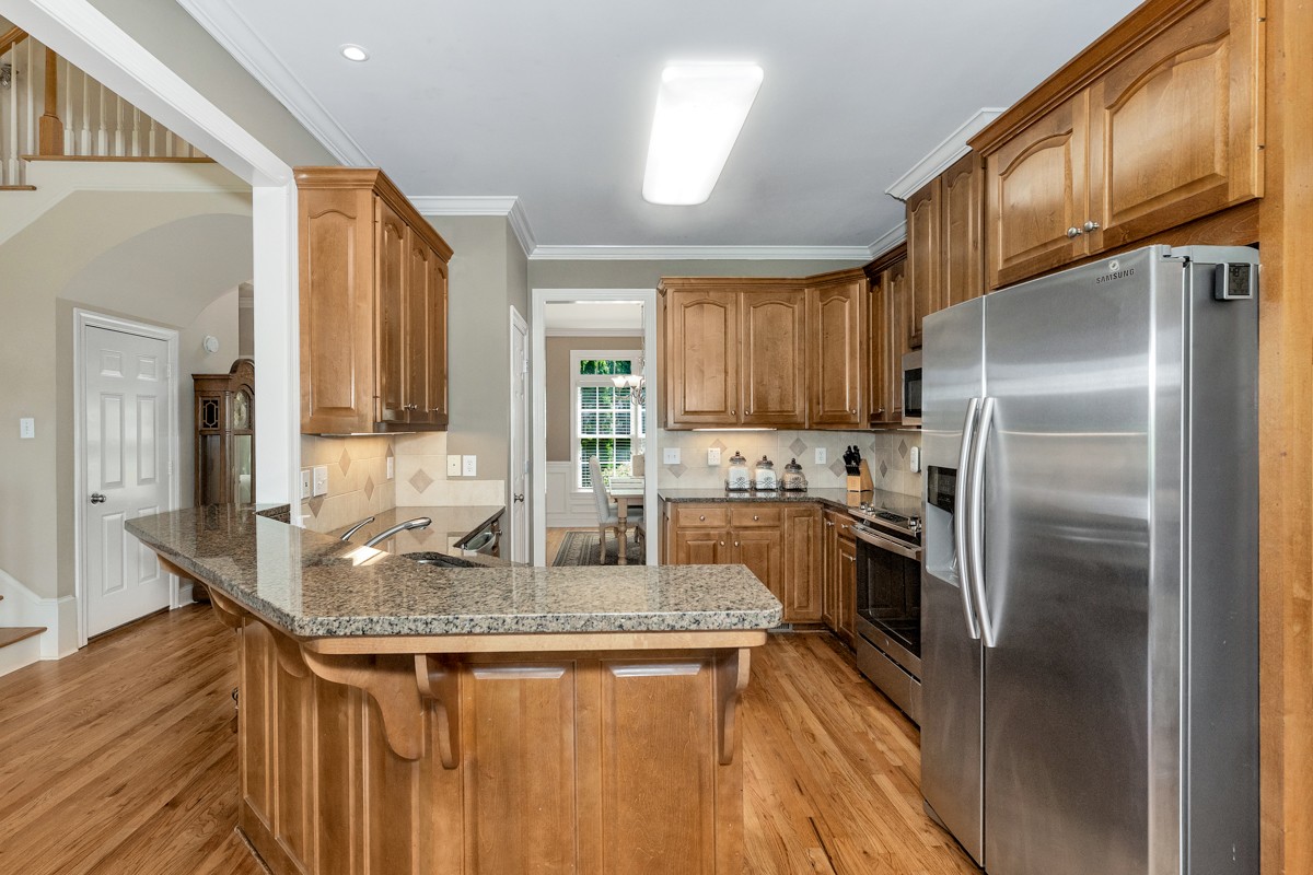 11035 Mathis Mountain Road Southeast Huntsville, AL 35803 - Photo 40 of 40 a kitchen with stainless steel appliances granite countertop a sink a stove and a refrigerator