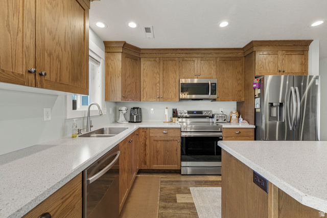 18573 South Marsh Valley Road Downey, ID 83234 - Photo 10 of 32 Kitchen featuring wood finish cabinets, stainless steel appliances, light stone counters, recessed lighting, and dark wood finished floors