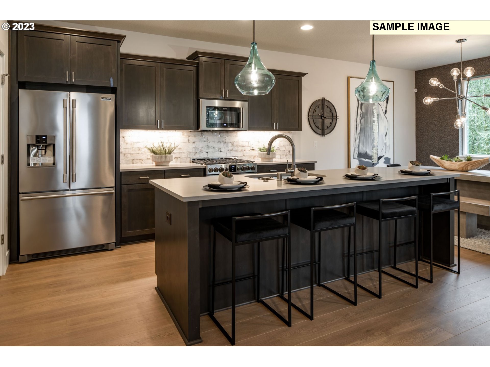 730 Northwest 178th Street Ridgefield, WA 98642 - Photo 7 of 21 a kitchen with stainless steel appliances granite countertop a sink and a refrigerator