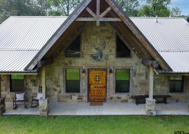 a view of a house with backyard porch and sitting area