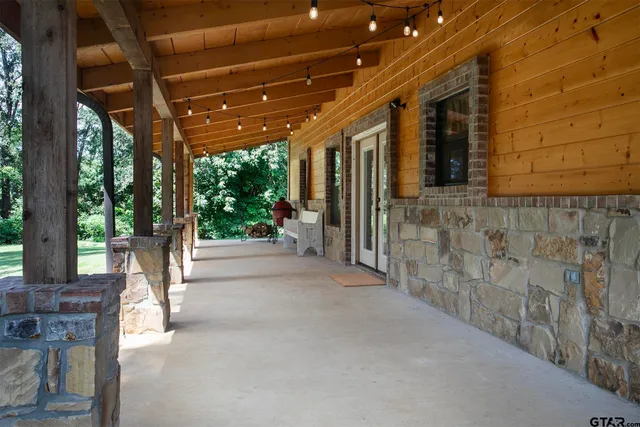 a aerial view of a house with a big yard plants and large trees
