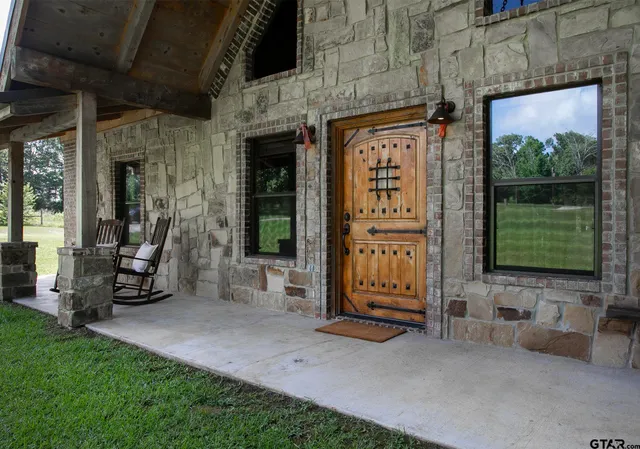 a living room with a fireplace and kitchen view
